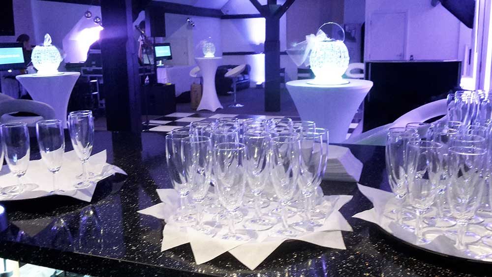 Glasses laid out on the bar before a function