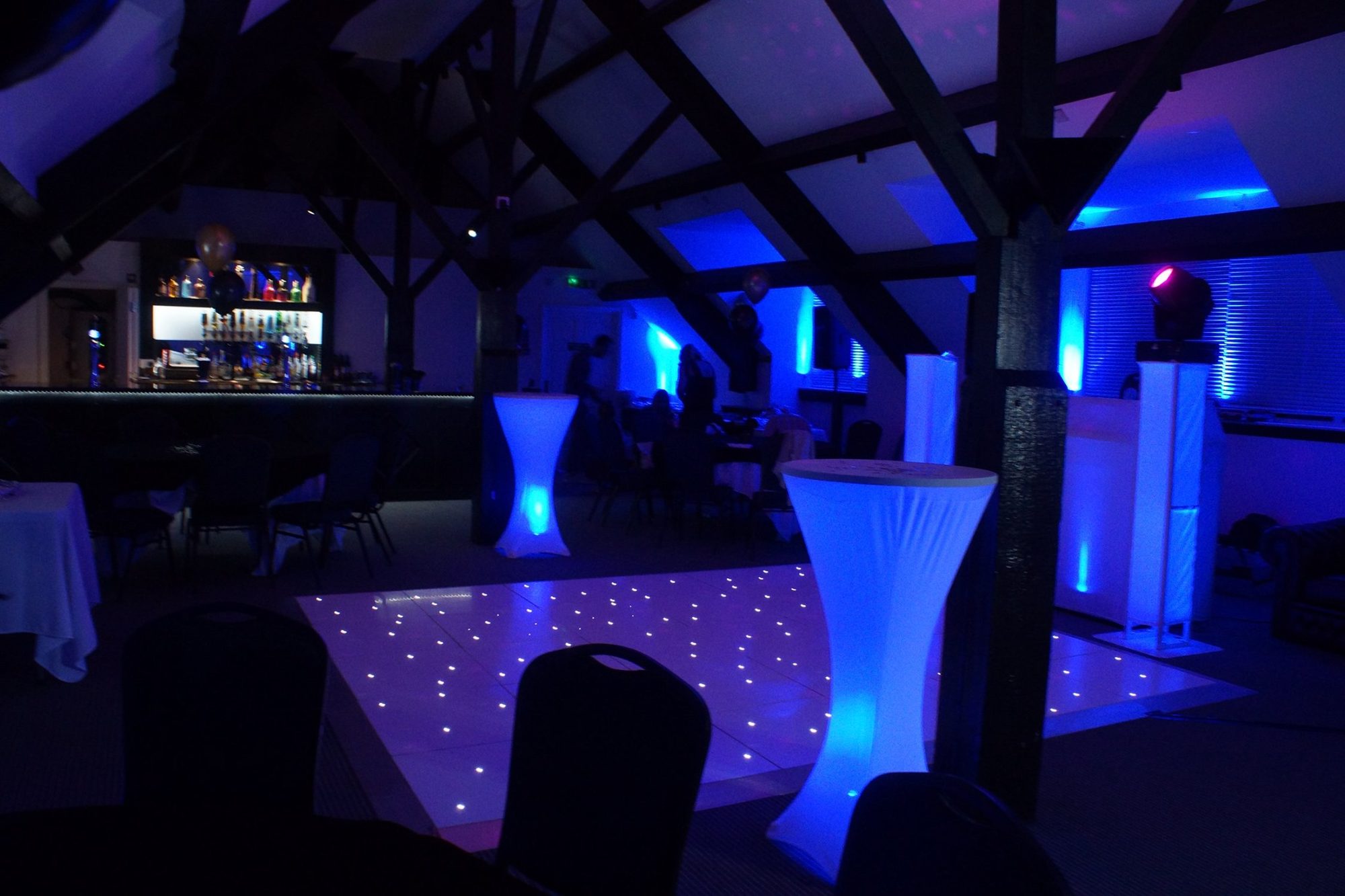 The function suite dressed for a party, with the dance floor lit